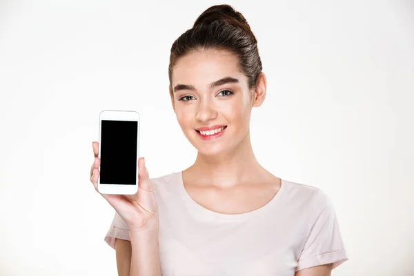 Portrait of smiling content woman demonstrating efficient cell p — Stock Photo, Image