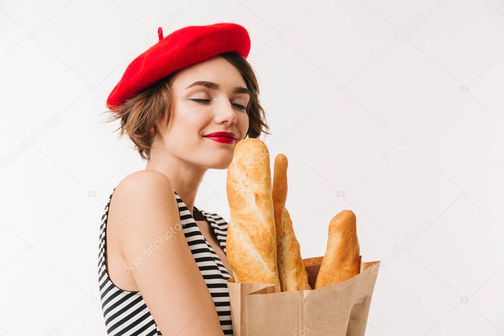 Portrait of a pretty woman wearing beret smelling