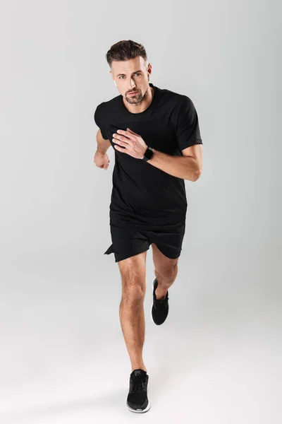 Retrato de comprimento total de um atleta maduro saudável correndo — Fotografia de Stock