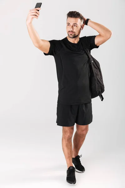 Full length portrait of a smiling mature sportsman — Stock Photo, Image