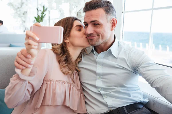 Portrait of a beautiful young couple taking a selfie — Stock Photo, Image