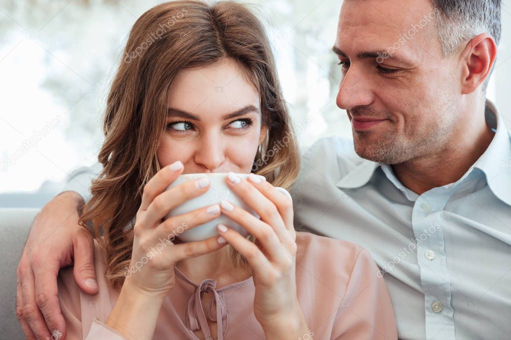 Portrait of a happy young couple drinking coffee