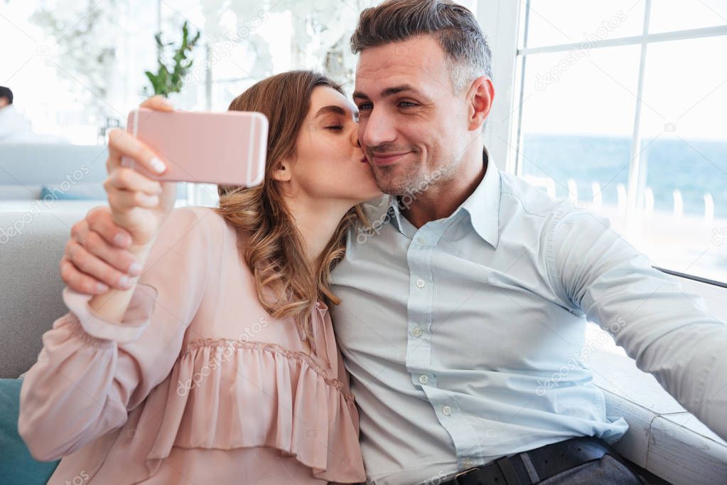 Portrait of a beautiful young couple taking a selfie