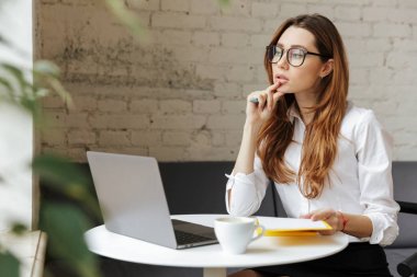 Düşünceli iş kadın kapalı dizüstü bilgisayar kullanarak