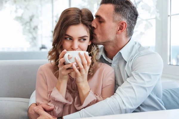 Picture of adult caring man hugging and kissing his girlfriend i — Stock Photo, Image