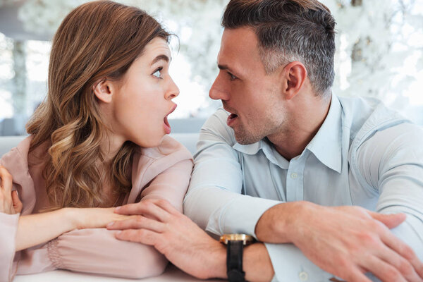 Surprised Lovely couple looking to each other