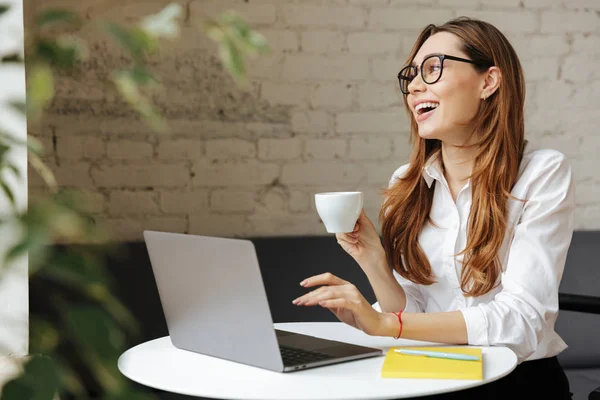 Unga leende business dam inomhus använder laptop — Stockfoto