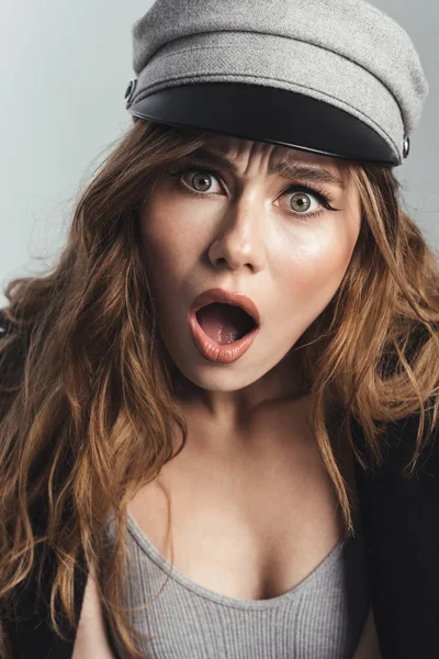 Fashion portrait of a surprised stylish curly brown haired woman — Stock Photo, Image