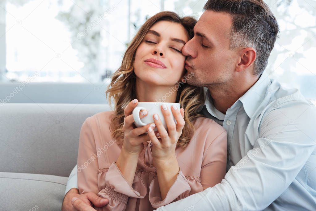 Photo of happy tender man and woman hugging and enjoying stay to