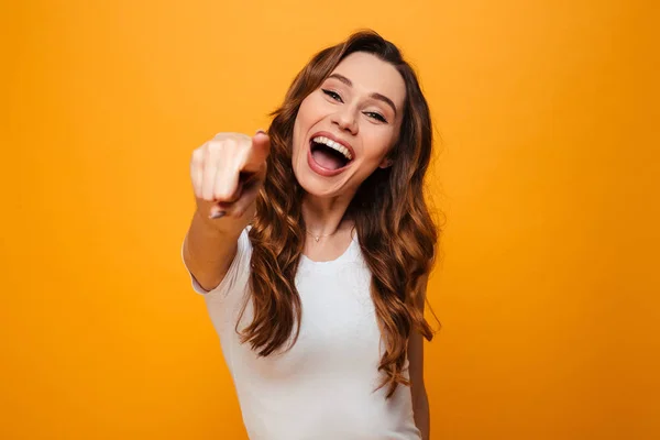 Cheerful brunette woman in t-shirt pointing at the camera — Stock Photo, Image