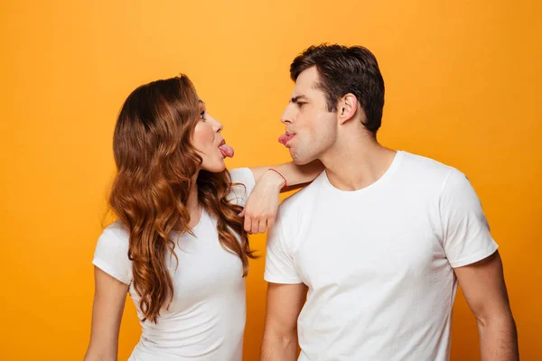 Portrait of funny man and woman in white t-shirts smiling and lo — Stock Photo, Image