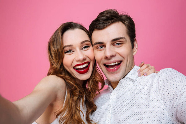 Portrait of loving couple hugging and looking on camera while ta