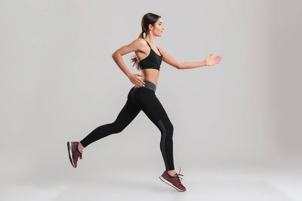 Profile picture of energetic caucasian female in sportswear runn — Stock Photo, Image