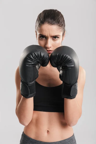 Photo of beautiful brunette sportswoman training in boxing glove — Stock Photo, Image