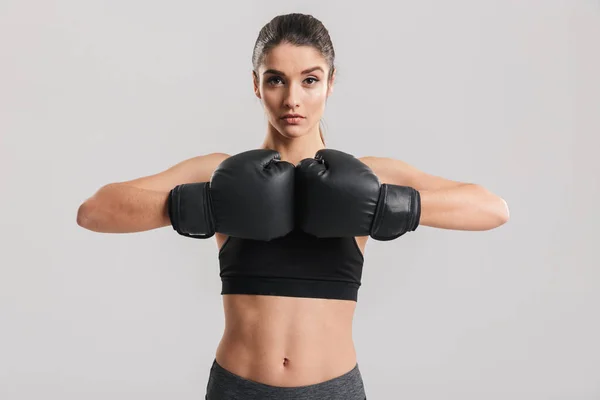 Picture of sporty brunette woman posing on camera with black box — Stock Photo, Image