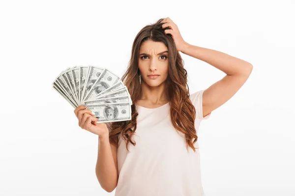 Συλλογισμένος μελαχρινή γυναίκα σε t-shirt εκμετάλλευση χρήματα — Φωτογραφία Αρχείου