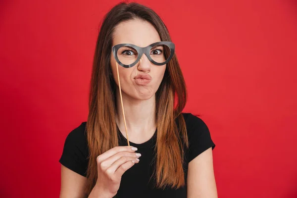 Portrait of a funny girl grimacing with fake eyeglasses — Stock Photo, Image