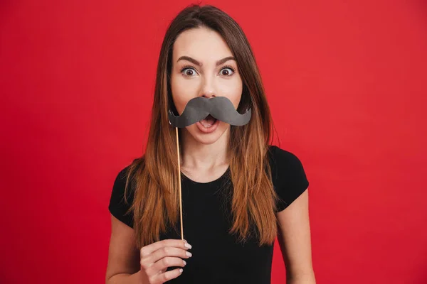 Retrato de una chica alegre haciendo muecas con bigotes falsos — Foto de Stock