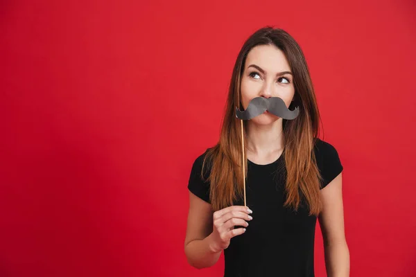 Portrait of a cheerful girl grimacing with fake moustaches — Stok Foto