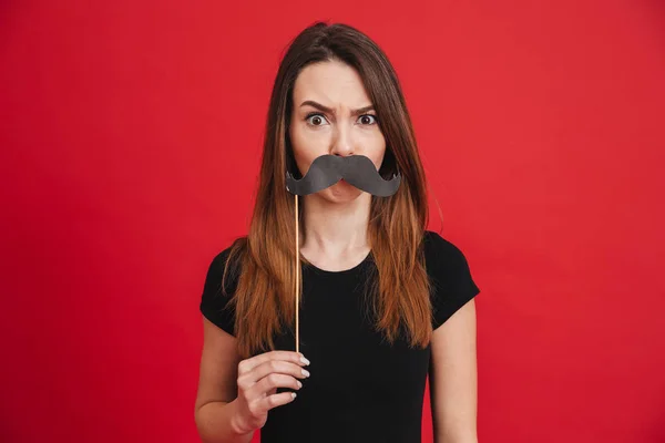 Portrait of a cheerful girl grimacing with fake moustaches — Stok Foto