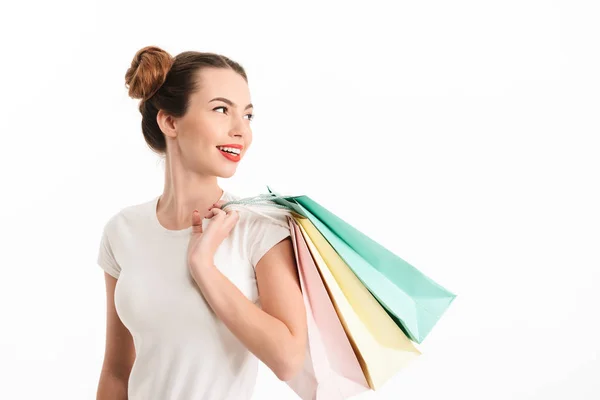 Portrait of a smiling casual girl holding shopping bags — Stock Photo, Image