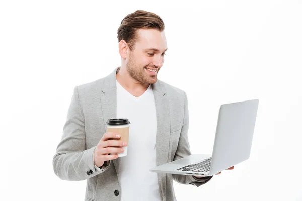 Vidám fiatal üzletember kávét használ laptop — Stock Fotó