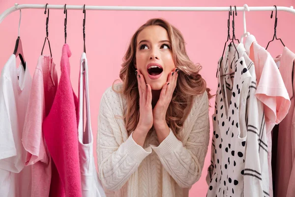 Shocked beautiful lady choosing clothes — Stock Photo, Image