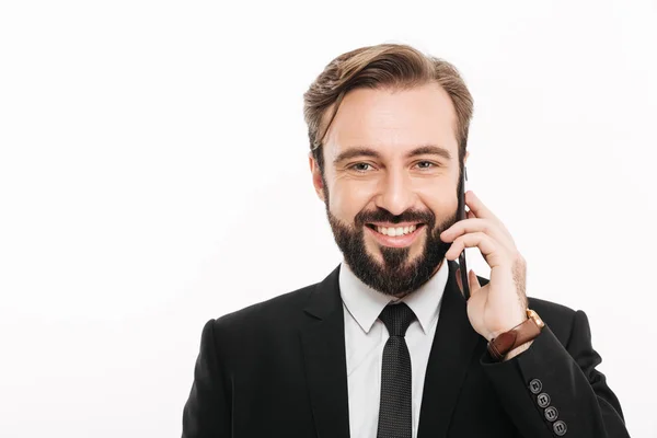 Smiling young businessman talking by mobile phone. — Stock Photo, Image