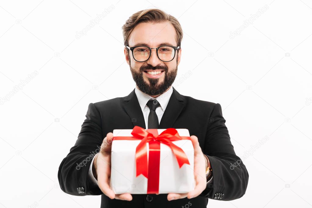 Handsome businessman gives you a gift present box.
