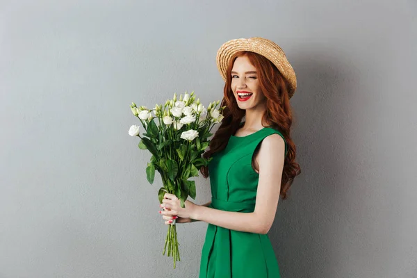 Redhead young cheerful woman with flowers. — Stock Photo, Image
