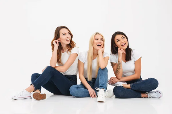 Young happy pretty girls friends sitting isolated — Stock Photo, Image