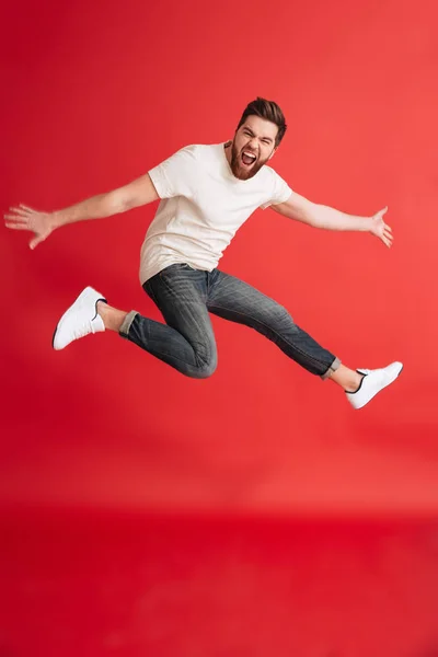 Excited emotional bearded man jumping — Stock Photo, Image