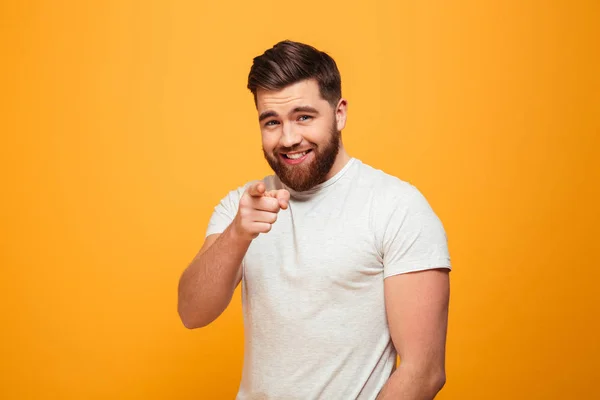 Portrait of a smiling bearded man pointing finger — Stock Photo, Image