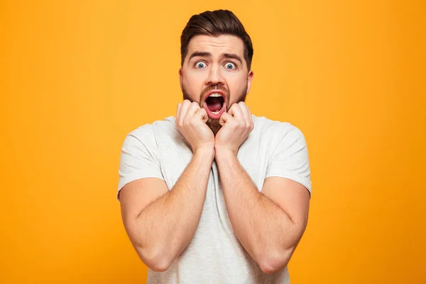 Portrait of a scared bearded man holding hands — Stock Photo, Image