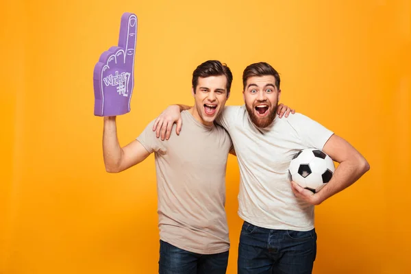 Portrait of a two happy young men holding soccer ball — Stock Photo, Image