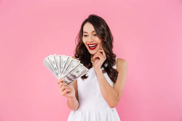 Image of happy rich asian woman smiling and looking on lots of m — Stock Photo, Image