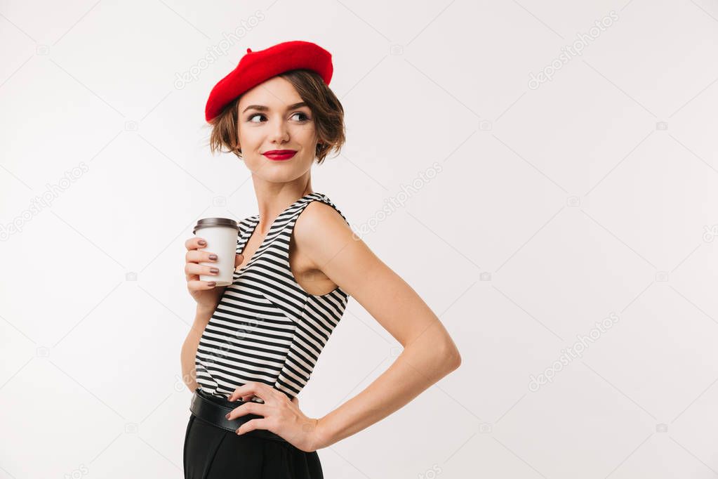 Attractive woman having french style wearing red beret posing on