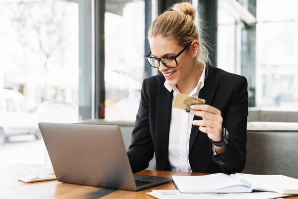 Lächelnde blonde Geschäftsfrau sitzt am Tisch im Café — Stockfoto