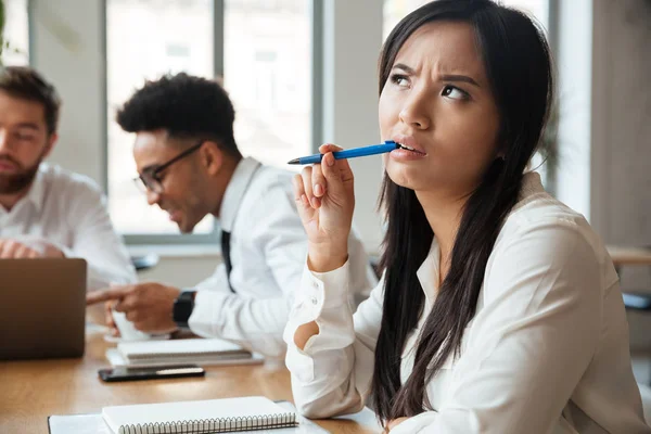 Pretty thinking young asian woman — Stock Photo, Image