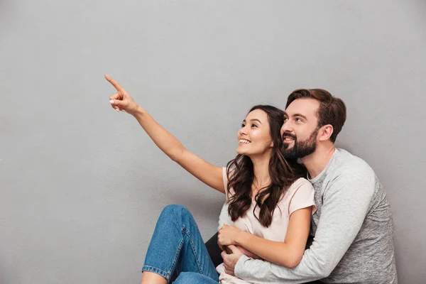 Homem alegre com sua esposa apontando . — Fotografia de Stock