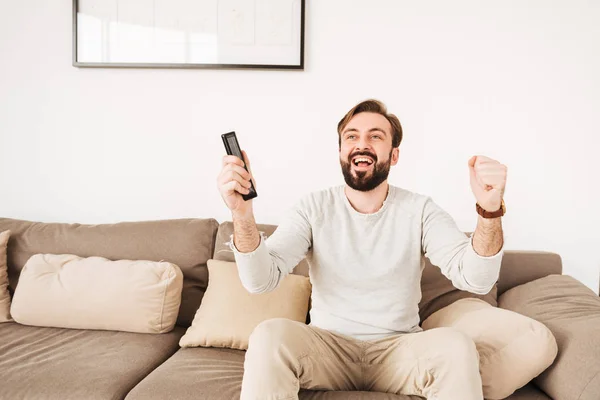 Excited cheerful guy having beard and mustache rejoicing win of — Stock Photo, Image