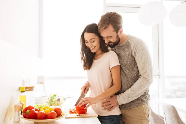 Portrait of a smiling young couple in love cooking — Stock Photo, Image