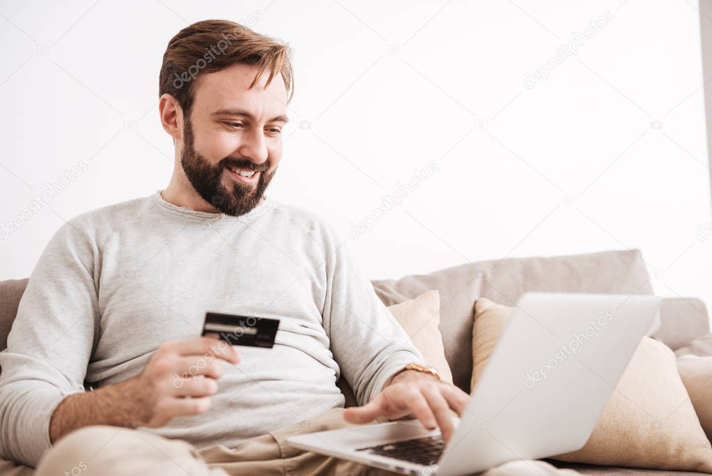 Portrait of a delighted man shopping online