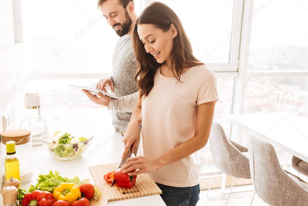 Portrait of a happy young couple cooking