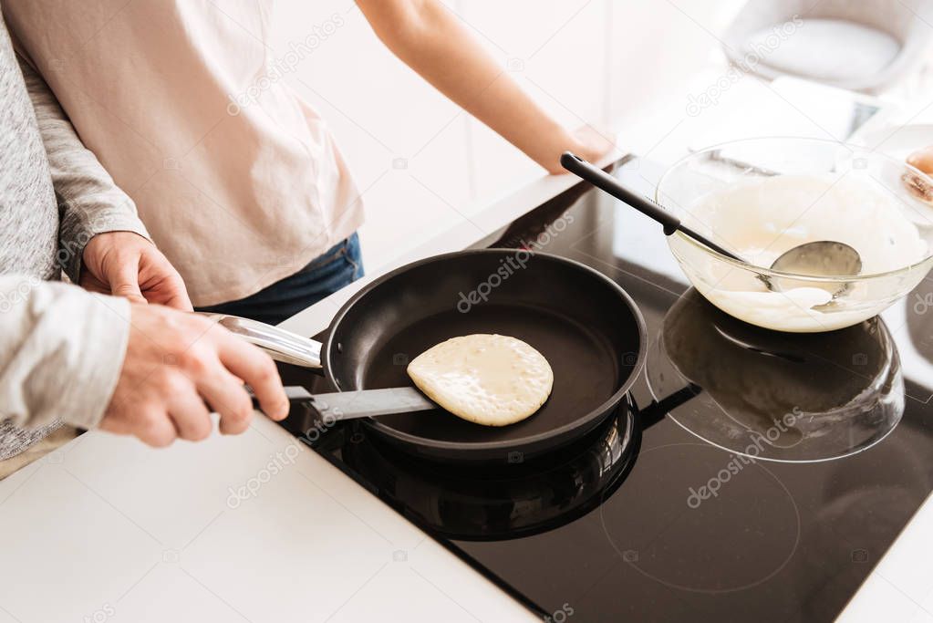 Close up of a couple cooking pancakes