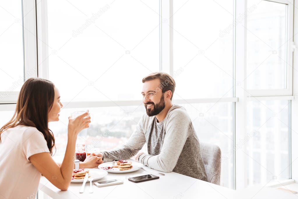 Happy young couple having breakfast