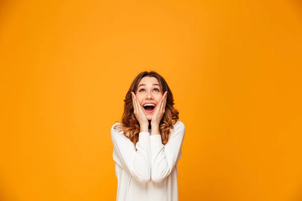 Surprised happy brunette woman in sweater holding her cheeks — Stock Photo, Image