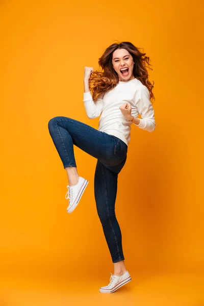Full length image of Cheerful brunette woman in sweater rejoices — Stock Photo, Image