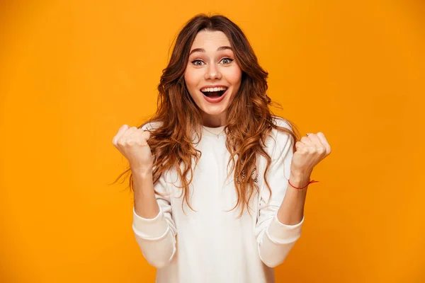 Surprised happy brunette woman in sweater rejoices — Stock Photo, Image
