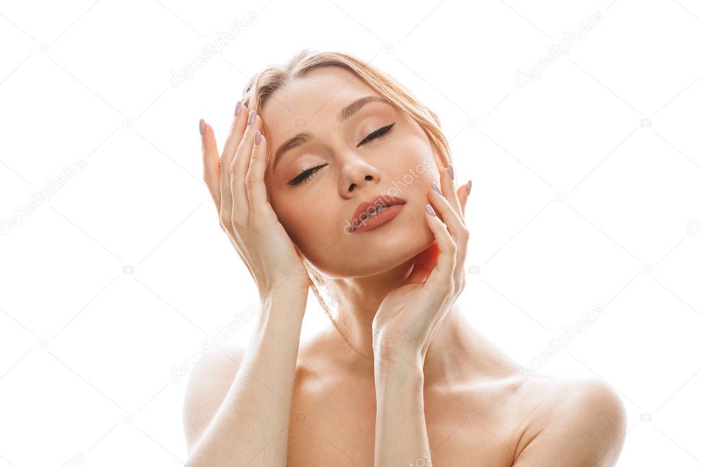 Pleased relaxed woman touching her clean skin and posing isolated